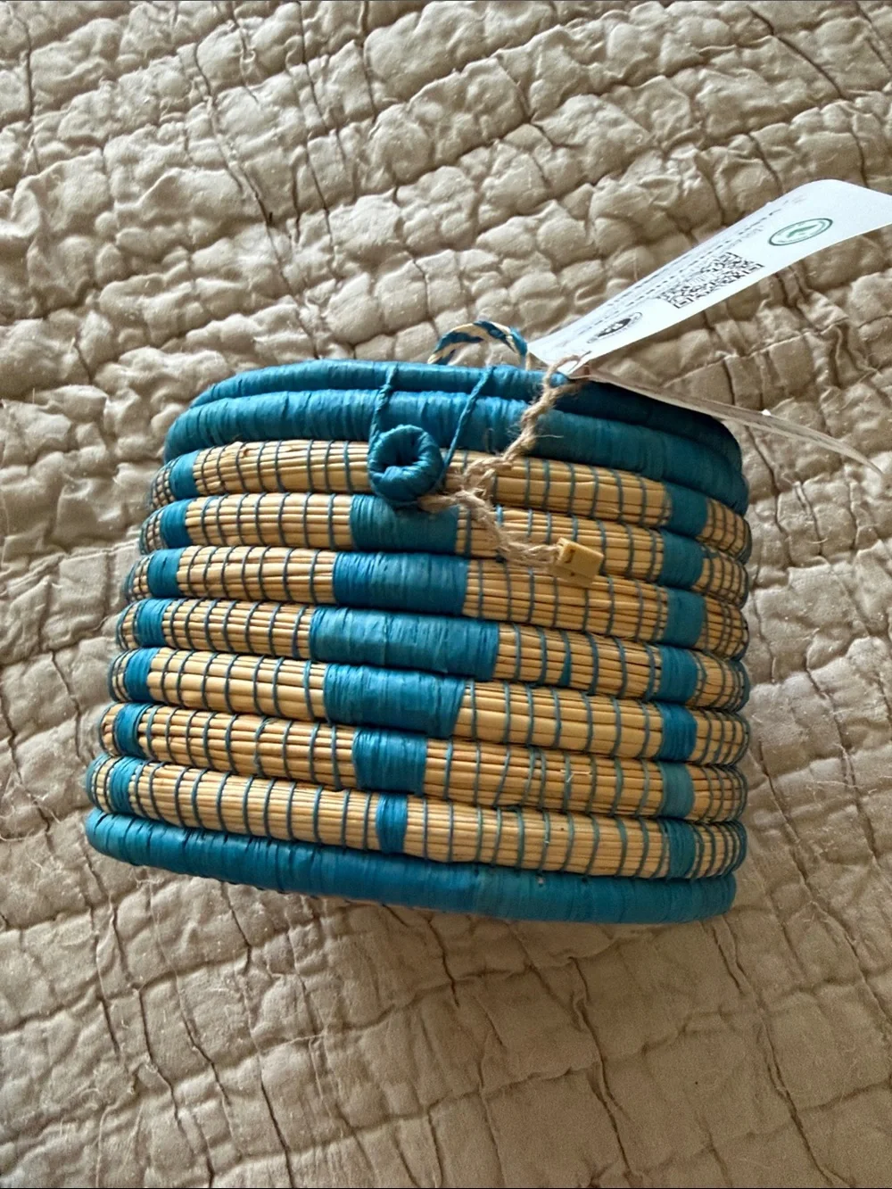 Handmade turquoise and tan coveted basket from Uganda clasp in the front